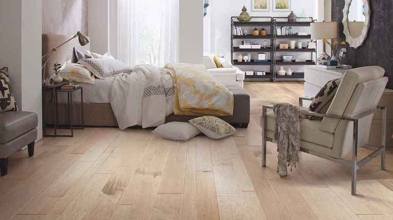 light blonde hardwood flooring in a bright and airy bedroom